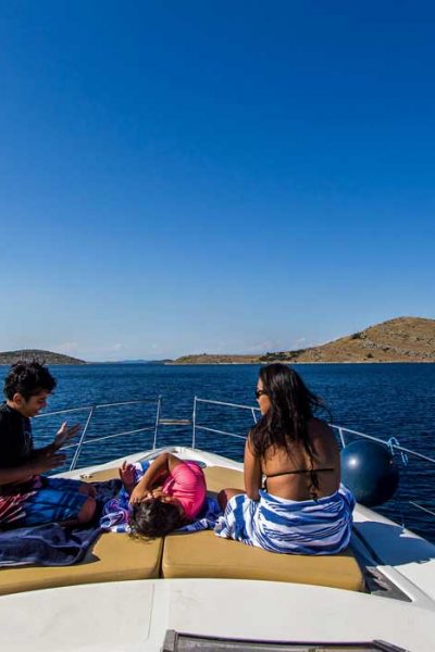 Sunbathing on deck while cruising Kornati Islands